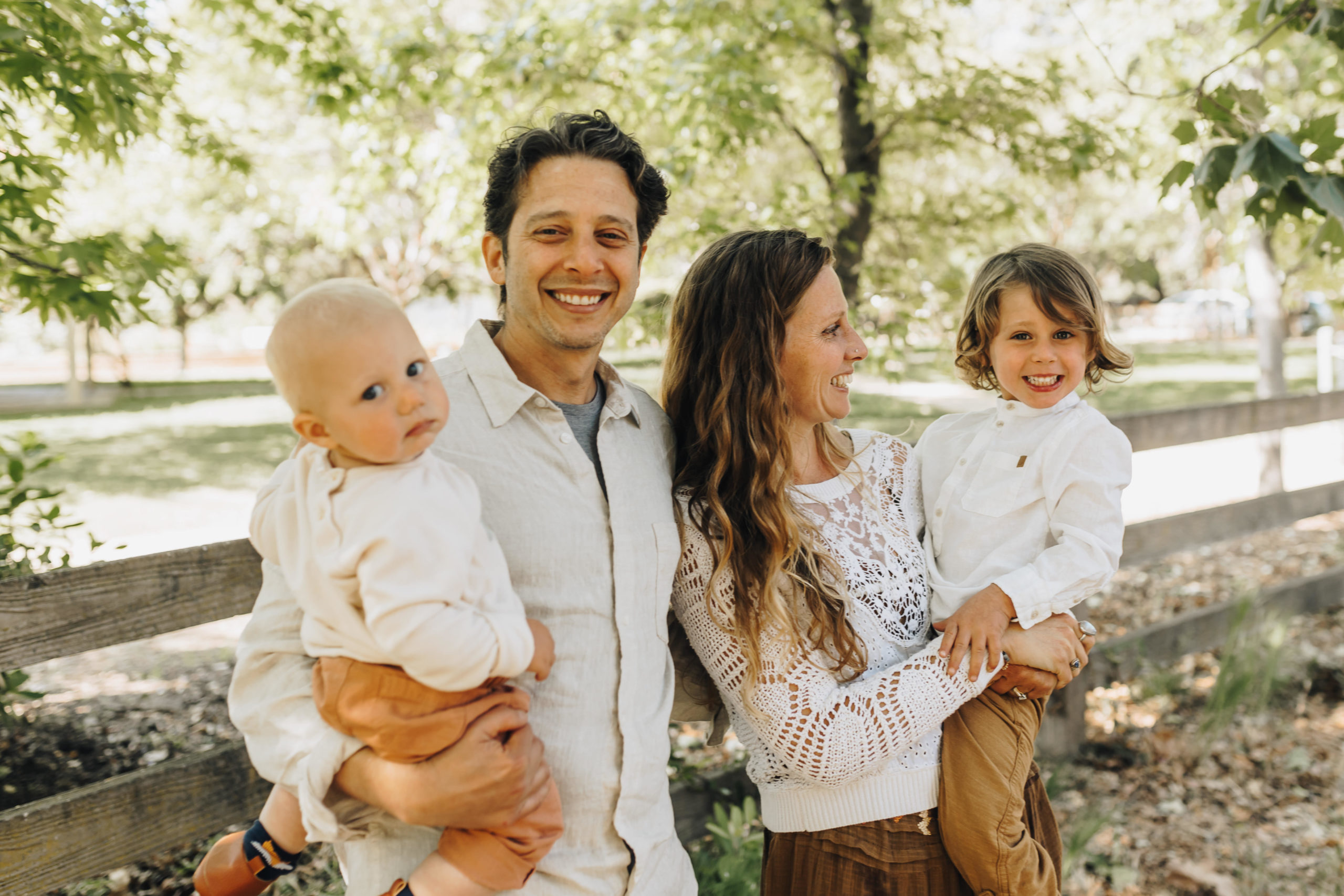 Family Cuddles together standing in park