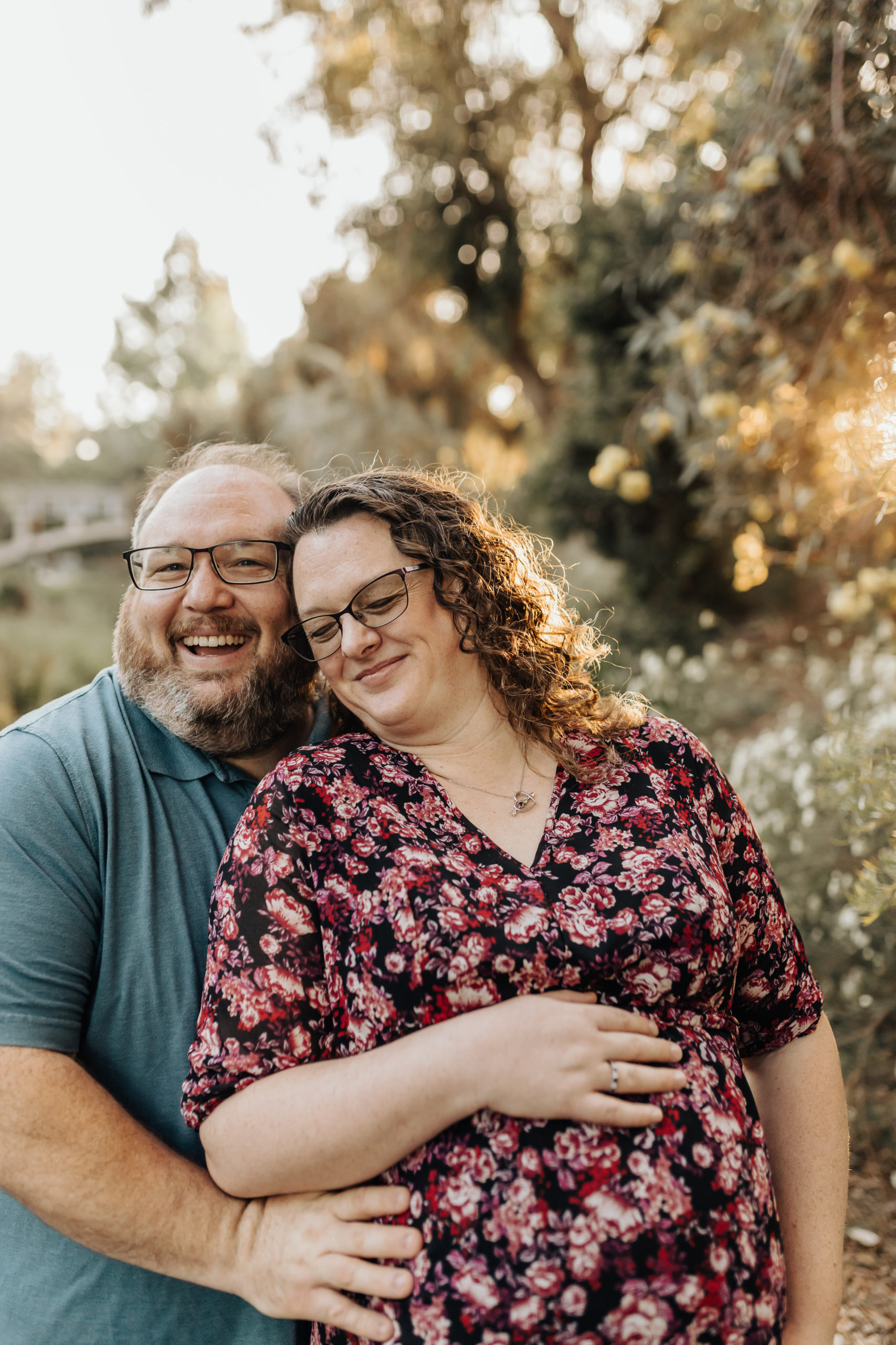 Pregnant Mom snuggles with husband