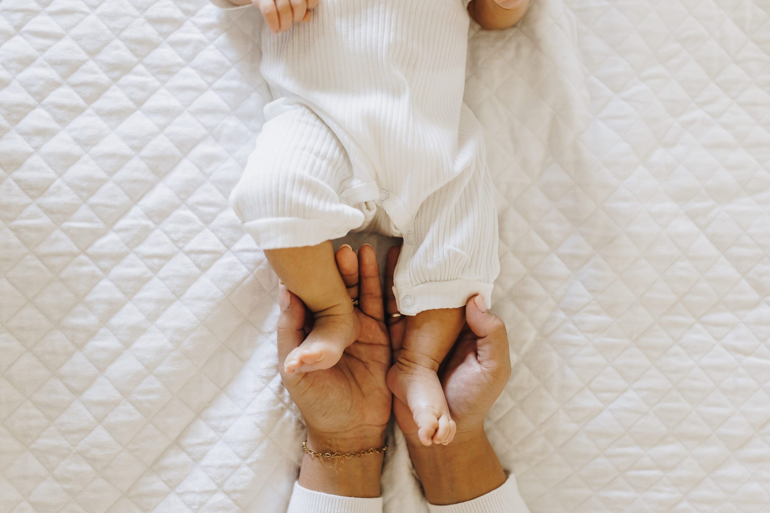 Hands holding baby's feet