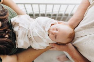 Overhead photo of sleeping baby swaddled