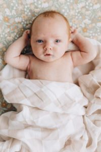 Baby lays in crib looking up