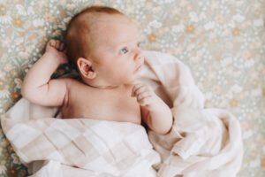 Baby lays in crib looking up