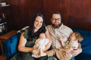 Whole family snuggles on the couch in-home family lifestyle session