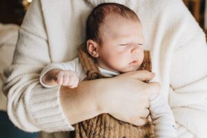 Mom holds sleeping baby