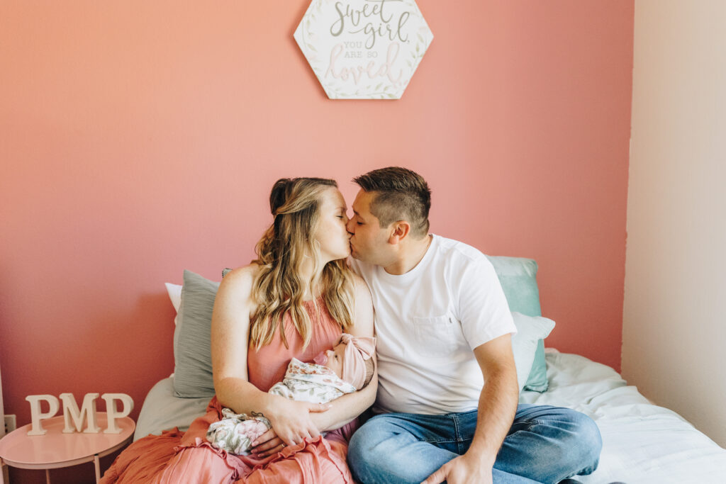 Mom and Dad hold their first baby at their second photo session