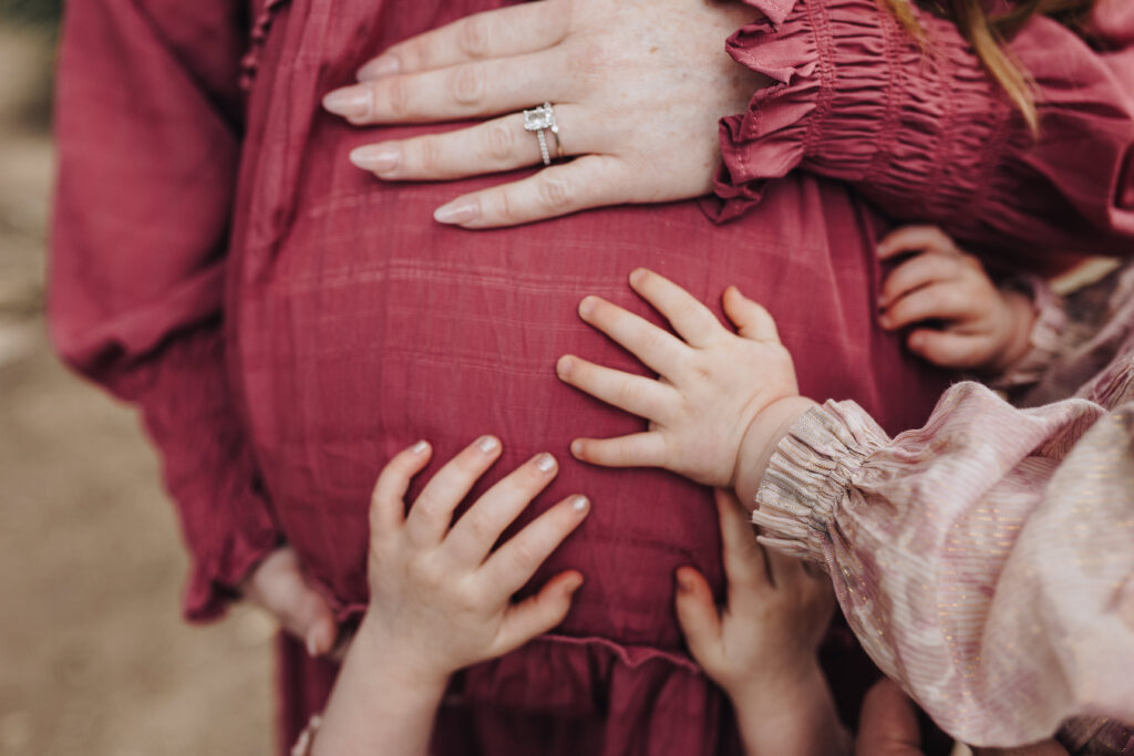 All the girls hands on their mamas belly.